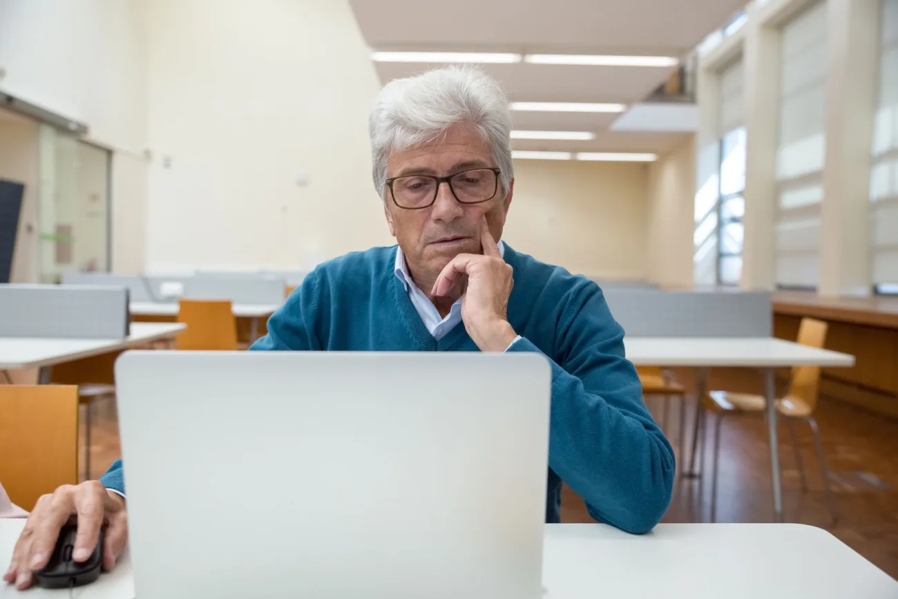 Mature student studying online with a laptop